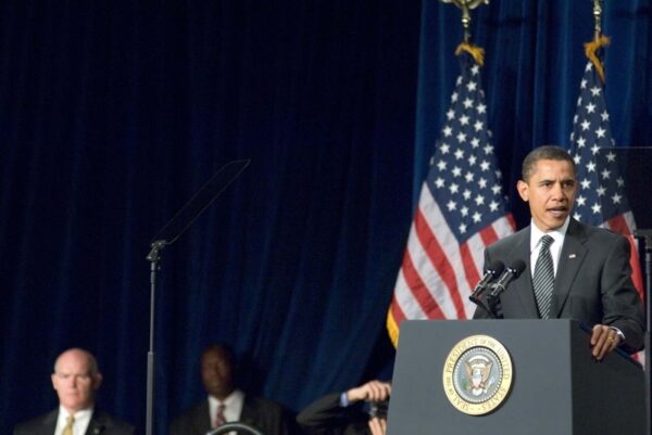 President Obama signing The Lautenberg Chemical Safety Act with a small group of people standing behind and watching him